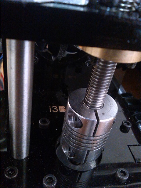 Sleeved lower ends of Z axis threaded rods.  Note machining of threaded rods, to extent of thread removal at ends, was necessary to fit sleeves.