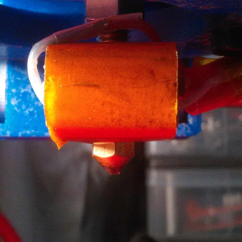 Facing the printer the tube and nozzle are in line.