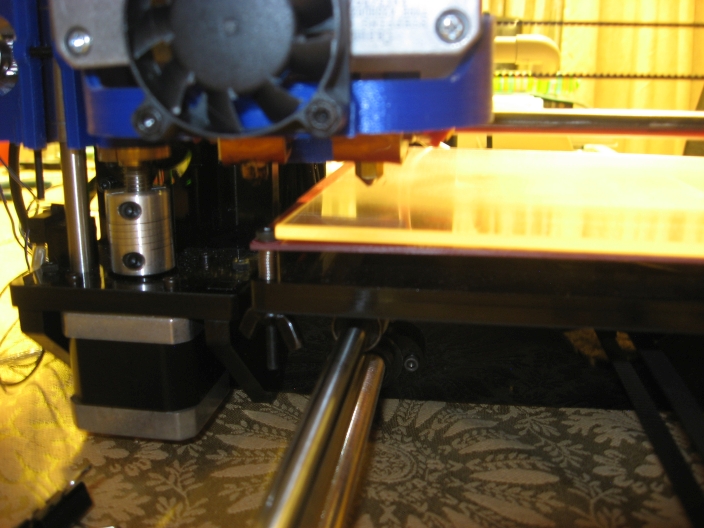 Corner or heat bed bends down, from the pressure from screws.